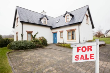 For sale signboard in front of house