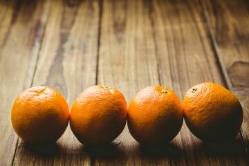 Close-up of oranges on wooden table