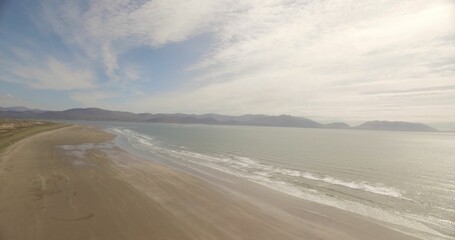 Sea shore against cloudy sky