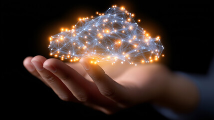 Hand holding a glowing digital cloud composed of interconnected data points, representing cloud technology.
