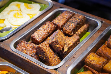 Traditional Indonesian Food, captured on July 10, 2025. Authentic dishes made with local spices, served with rice, meats, vegetables, and sambal for rich flavor.