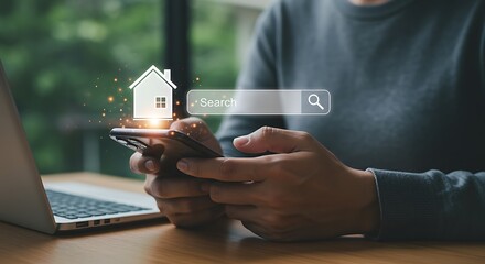 Person searching for a house online using a smartphone and laptop