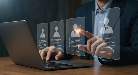 Businessman selects candidate profile from digital interface on laptop