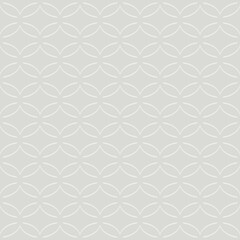 Fototapeta premium A repeating pattern of interlocking circular shapes creates an intricate design in shades of gray. The symmetrical arrangement provides a sense of order and balance.