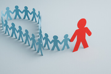 Leadership and influence concept with red paper figure leading the crowd, Red paper leader among blue figures