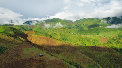 Aerial landscape view of greenery mountain on foggy day drone