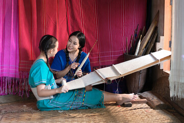 Beautiful Young Women Learning Traditional Karen Weaving in Chiang Mai, Thailand.