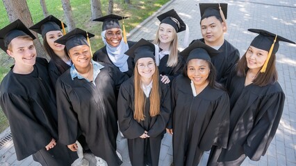 Multinational students in graduation gowns. 