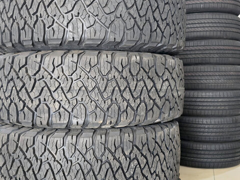 pile of tires in a tire shop, automotive business concept and various types of tire treads