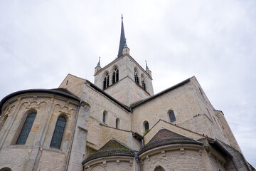 Looking up abbey church at Swiss city of Payerne on cloudy spring day. Photo taken June 6th, 2025, Payerne, Switzerland.