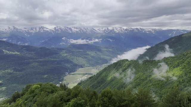 Aerial view of foggy Caucasus mountains near Koruldi Lake in Mestia, Georgia on a cloudy day