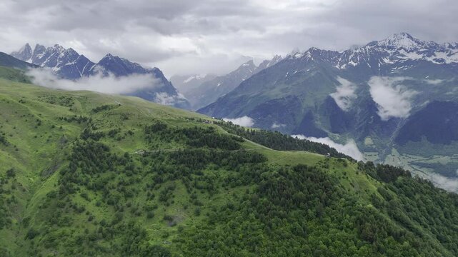 Aerial view of foggy Caucasus mountains near Koruldi Lake in Mestia, Georgia on a cloudy day