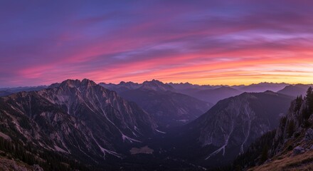 Obraz premium Majestic Mountain Sunset Panorama - Breathtaking panoramic view of mountains at sunset, vibrant pink and purple hues in the sky. Serene landscape