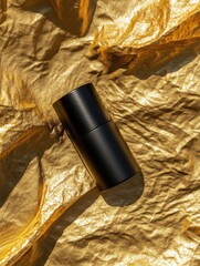 Sleek Black Container on Textured Gold Background for Product Display