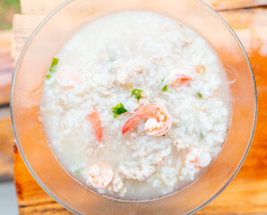 Top view and close up. Boiled rice soup in bowl with shrimp and minced pork is simple but healthy dish that is suitable for breakfast.