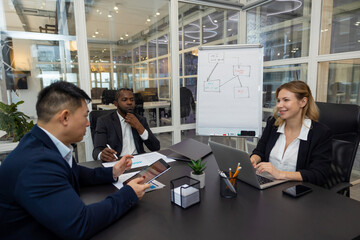 Colleagues working on a new project in the office and discussing the ideas