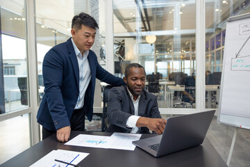 Colleagues working on a new project in the office and discussing the ideas