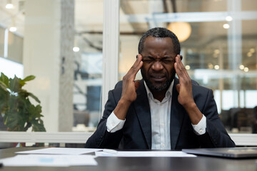 African american businessman having a headache after a busy working day