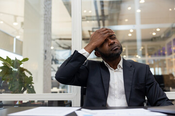 African american businessman having a headache after a busy working day