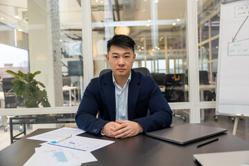 Asian young businessman working in his office and looking busy
