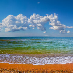 wide sandy sea beach under a cloudy sky, summer sea vacation scene