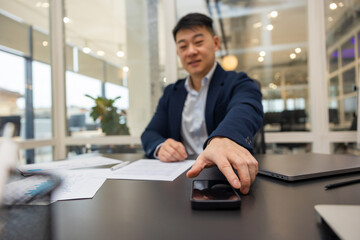 Fototapeta premium Young asian manager working in the office on a new project