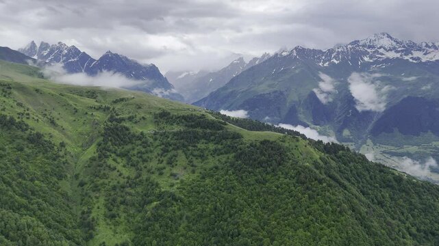 Aerial view of foggy Caucasus mountains near Koruldi Lake in Mestia, Georgia on a cloudy day