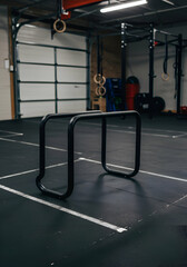 Black parallel bars in a fitness center. Stationary equipment in a gym setting. Professional fitness equipment in a commercial gym -