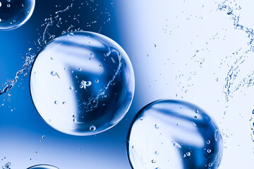 3D render of transparent water bubbles with splashes on a blue background. Abstract hydration and...