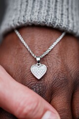 Hands uniting in solidarity, showcasing a heart-shaped pendant during a moment of connection and empathy among diverse individuals. MedicAlert Awareness Month