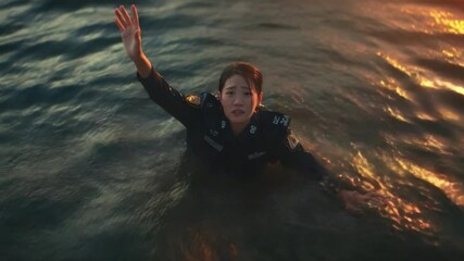 Drowning in Despair: A person struggles in deep water, arms raised in a desperate attempt to call for rescue or signal for help, highlighting the vulnerability and danger of the ocean.