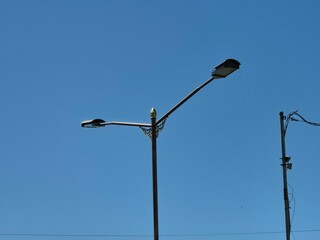 Modern LED Streetlight Mounted on a Metal Pole Against a Clear Blue Sky