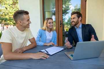 Real estate agent discussing deal details with the clients