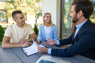 Real estate agent discussing deal details with the clients