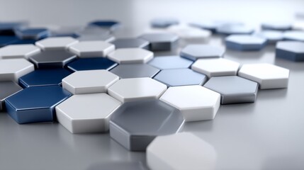 Abstract geometric pattern of hexagonal shapes in various shades of gray and white, suggesting innovation, technology, or modern design.