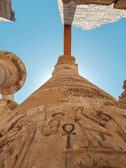 Karnak temple column reaching for the sky with ancient egyptian hieroglyphs