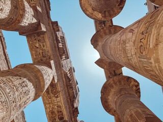 Majestic columns and architrave soaring into the vibrant blue sky at dendera temple complex