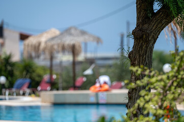 Relaxing around a tranquil pool in Crete Greece on a sunny day