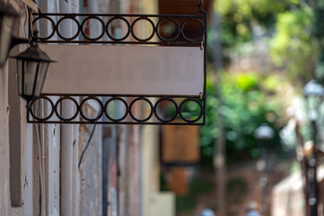 Blank signboard mockup on a quaint street with decorative urban elements in daylight