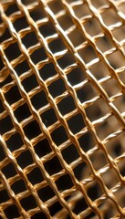 macro texture of polished gold wire mesh with gradient shine and metallic detail.