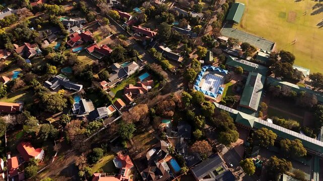 Drone tilt-up over Randburg suburb in Johannesburg next to school grounds