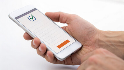 Hand holding smartphone displaying checklist with a checkmark.