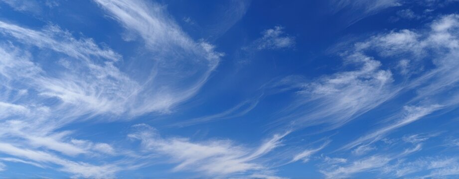 The ethereal beauty of wispy clouds in a bright blue sky.