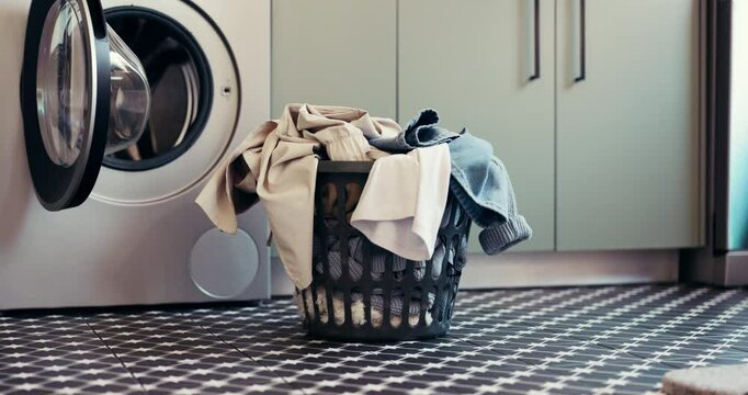Laundry, washing machine and basket with clothes in home for maintenance, housework or hygiene. Empty, apartment and container with textiles, fabric and material for housekeeping, cleaning or chores