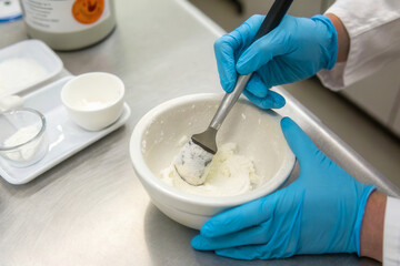 x-default Scientist mixing white powder in a mortar