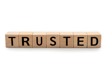 Wood cube block with TRUSTED text isolated on white background. Brand building for success concept....