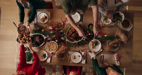 Food, family and Christmas dinner in home for festive celebration, event or party together. Dishing, top view and people in dining room for carving meat with gourmet meal, feast or supper for xmas. - Powered by Adobe