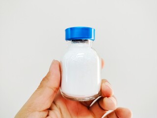 50 ml glass bottle containing medicine