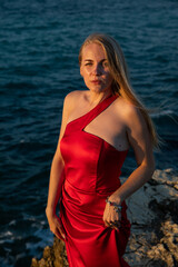 Portrait of a beautiful woman in a red evening dress
