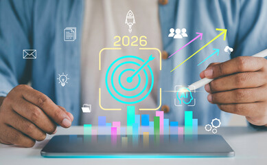Freelancer use tablet setting tasks and goals. Target and business strategy planning. analyzing performance data, and improving productivity effective strategy 2026. project management. marketing data